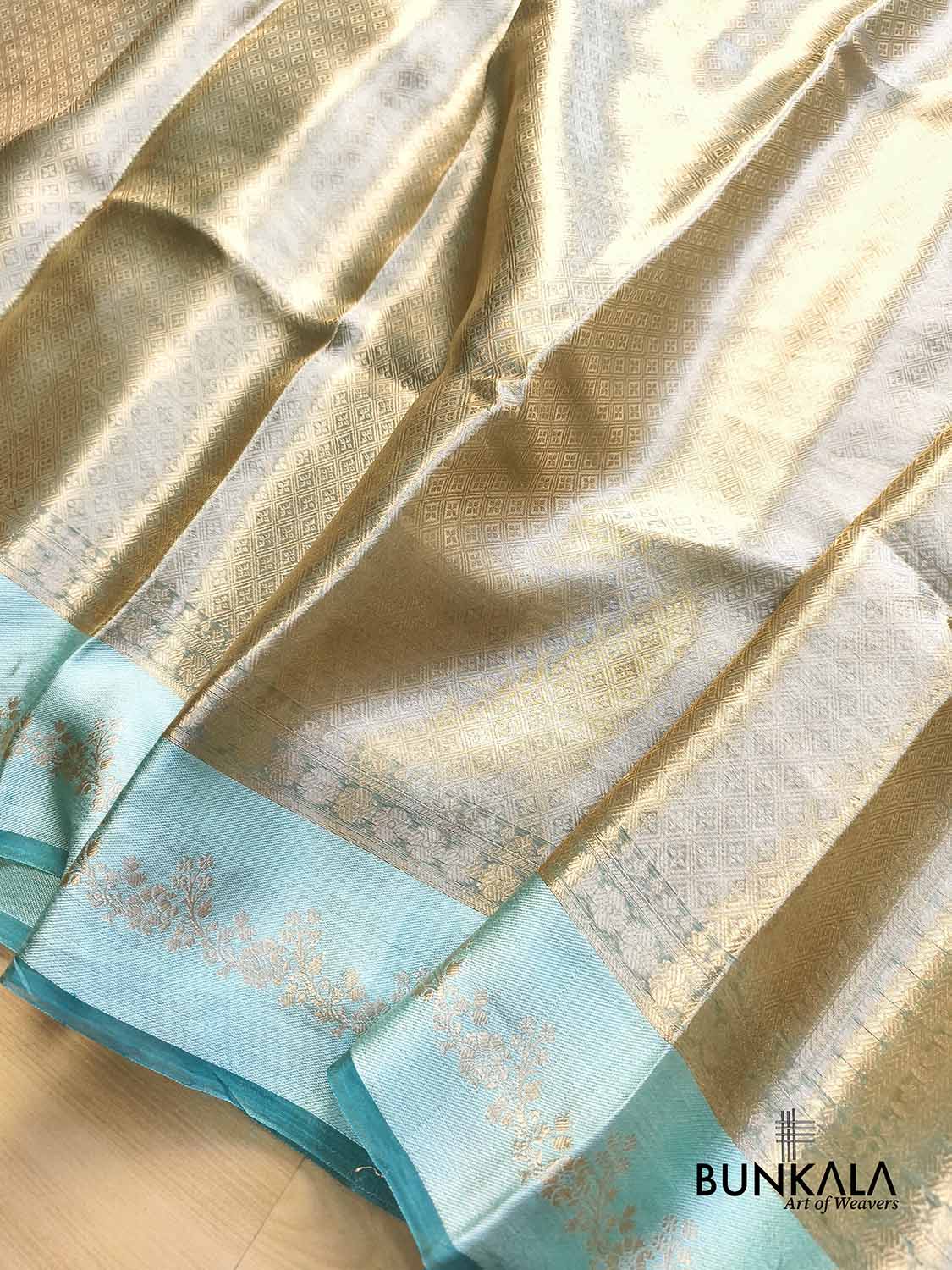 Golden Brocade Handloom Banarasi Pure Tissue Saree with Contrast Bright Sky Blue Katan Silk Floral Border
