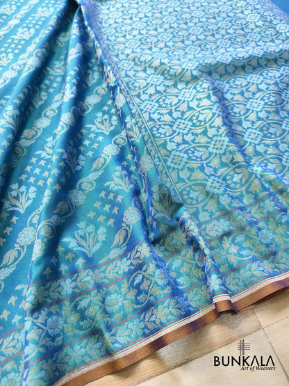 Turquoise blue Ektara Banarasi Jamdani silk saree with intricate floral weaving, elegant border and matching blouse for festive occasions.