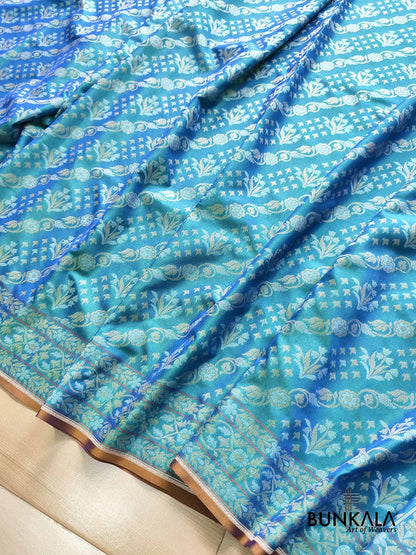 Turquoise blue Ektara Banarasi Jamdani silk saree with intricate floral weaving, elegant border and matching blouse for festive occasions.