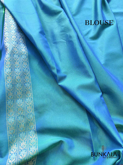 Turquoise blue Ektara Banarasi Jamdani silk saree with intricate floral weaving, elegant border and matching blouse for festive occasions.